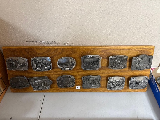 12 ct. Assortment of Iowa Farmer Collectible Belt Buckles on wood display board