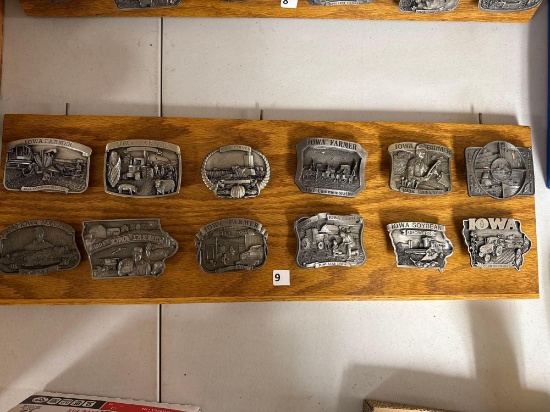 12 ct. Assortment of Iowa Farmer Collectible Belt Buckles on wood display board