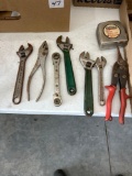 Crescent wrenches , tape measure, pliers, ratchet wrench, tin snips.