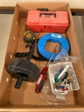 Steel fish tape, plastic tool box of drill bits, tape measure, electrical parts