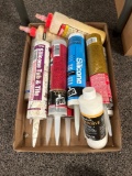 Box of assorted caulk and glue