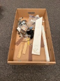 Box of assorted nails, screws, and wood parts