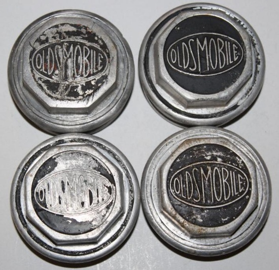 Group of 4 Oldsmobile Motor Car Co Threaded Hubcaps