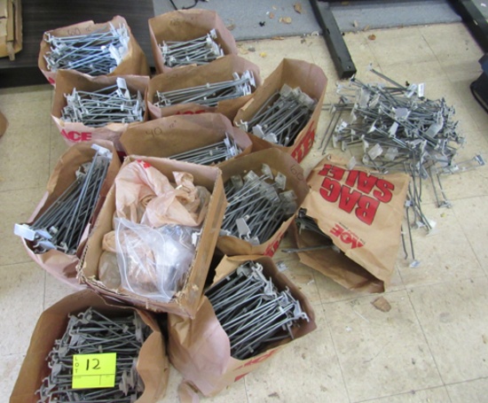 12 bags of peg board display hooks & a pile on floor