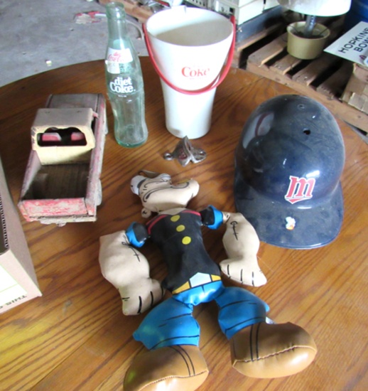 Popeye toy, toy truck, Diet Coke glass and cup