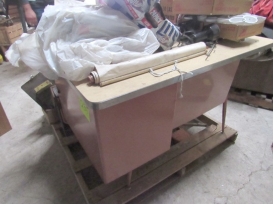 Pink desk and pallet of miscellaneous