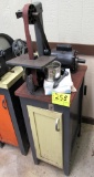 Delta sander grinder on cabinet