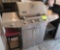Aussie gas grill, small table and bar stool