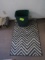 rug and trash can