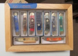 9 knives in wooden display box