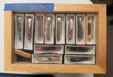 12 knives in wooden display box