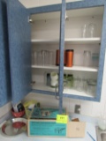 items on counter and glasses in cabinet