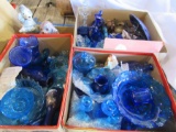 4 boxes of blue glassware and 2 pup figurines