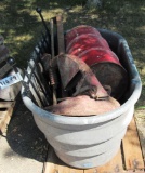 water tank, tractor seat, metal can, chicken feeder, fence