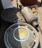 chevy hub caps, tractor seat, muffler, basketball hoop