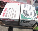2 boxes scotch-brite scouring pads, 4 antique oil cans
