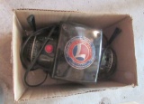 box of train controllers by Lionel