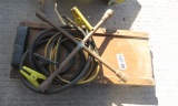 tire iron, creeper, jumper cables, gas hose