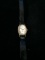 Vintage Timex Women's Gold and White Tone Watch with Black Leather Band