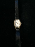 Vintage Timex Women's Gold and White Tone Watch with Black Leather Band