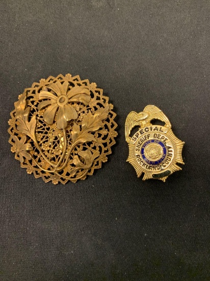 Lot of Two Gold-Tone Alloy Brooches, One Round Floral Motif & One NY Sheriff Department
