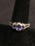 Three Graduating Oval Faceted Tanzanite Centers CZ Halo Decorated 8mm Wide Tapered Three-Stone
