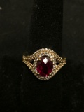 Oval Checkerboard Faceted 9x7mm Created Ruby Center Double CZ Halo Gold-Tone Signed Designer