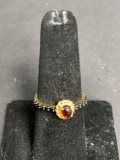Oval 5x3mm Garnet Cabochon Rope Detail Halo & Black CZ Sides Gold-Tone Sterling Silver Ring Band