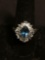 Oval Faceted 9x7mm Blue Topaz Center w/ Alternating Blue Topaz Pear & White CZ Baguette Halo