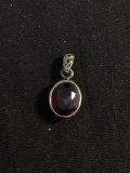Oval Faceted 11x9mm Garnet Center Filigree Decorated Sterling Silver Pendant