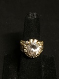 Oval Faceted 12x10mm CZ Center w/ Round CZ Halo & Baguette Accented Shoulders Gold-Tone Signed
