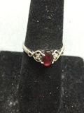 Oval 7x5mm Garnet Cabochon Center Heart Detailed Sterling Silver Ring Band