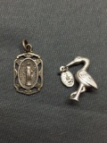 Lot of Two Catholic Themed Sterling Silver Items, One Virgin Mary Pendant & One Stork w/ Baby Girl