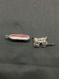 Lot of Two Sterling Silver Charms, One Enameled Skateboard & Covered Wagon