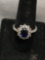 Oval Faceted 9x7mm Created Blue Sapphire Center w/ Round Faceted CZ Accented Halo & Round Diamond