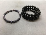 Lot of Two Beaded 7in Bracelets, One Black Bead Coil and One Pearl Beaded