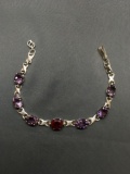 Infinity Link Design 9in Long Bracelet w/ Oval Faceted 11x9mm Ruby Center & Six Oval Faceted 10x8mm