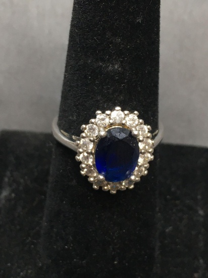 Oval Faceted 9x7mm Created Blue Sapphire Center w/ Round Shared Prong Set CZ Halo Sterling Silver
