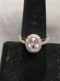 Oval Faceted 8x6mm CZ Center w/ Round CZ Accented Halo & Shoulders High Polished Sterling Silver