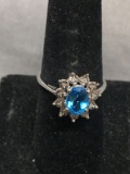 Oval Faceted 8x6mm Blue Topaz Center w/ Illusion Set Round Faceted Diamond Halo 14kt White Gold Ring