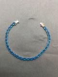 Oval Faceted 6x4mm Blue Topaz Featured Gemstones 8in Long Sterling Silver Tennis Bracelet