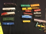 Lot of approx 17 HO scale train cars and locomotives.