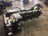 Lowe Manufacturing Co. Hydraulic Skidloader trencher attachment.