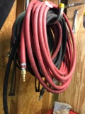 Various air hoses, and a set of torch hoses