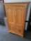 112. Wood entertainment cabinet with brass knobs. Unit has electrical outlets in upper portion of