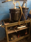 Rolling shop cart with fluid bucket pumps, grease gun, oilers and more.