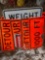 Stack of like new metal road construction signs.