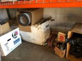 Shelf load of old computer, Christmas tree, sandpaper, bike parts, large truck filter and radiator