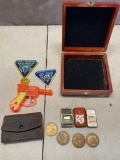 Wooden box, 2 Zippo lighter and one off brans, friction cap gun, tokens and more