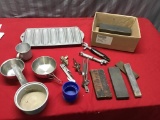 Collection of vintage kitchen utensils and sharpening stones